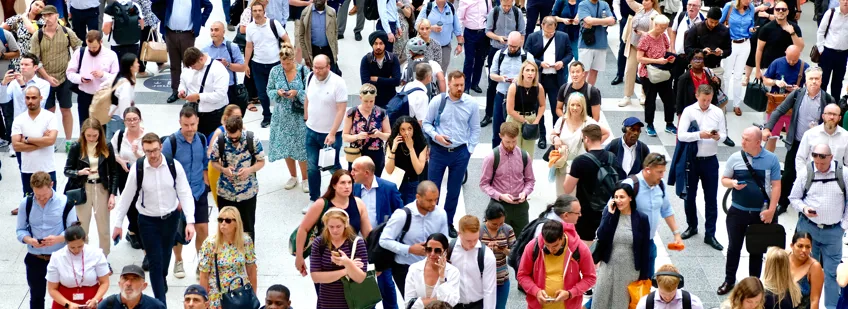A crowd of people waiting for a train at Liverpool Street, London